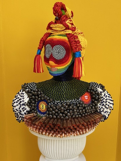 Sculpture of a bust: "Treat Me Right"
2024
Glass beads, nylon fringe, tin jingles, vintage pinback buttons, metal bells, plastic bone pipe beads, cold-rolled mild steel, nylon thread, acrylic felt, steel plate, marble base 